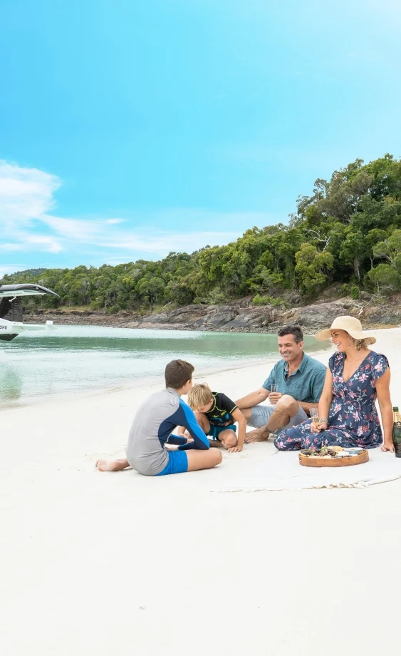Family on Whitehaven Beach near Airlie Beach