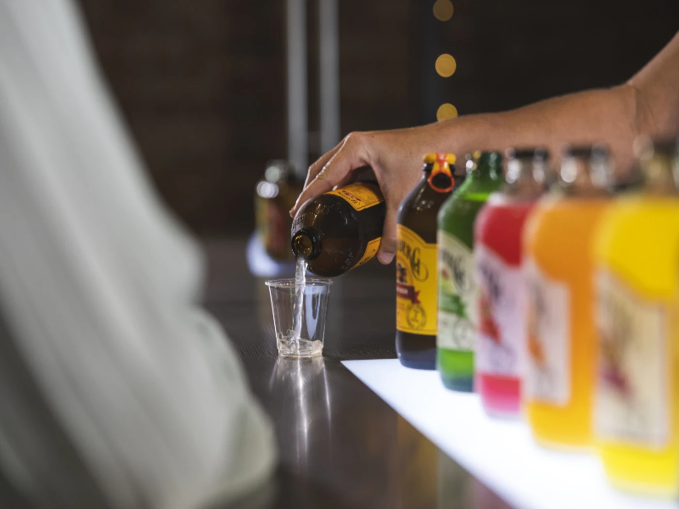 Taster of Bundaberg ginger beer being poured with other products lined up beside