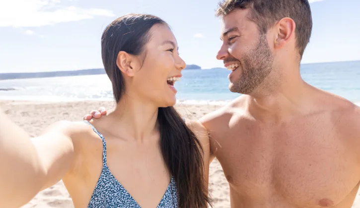 Happy couple taking selfie on an Australian beach