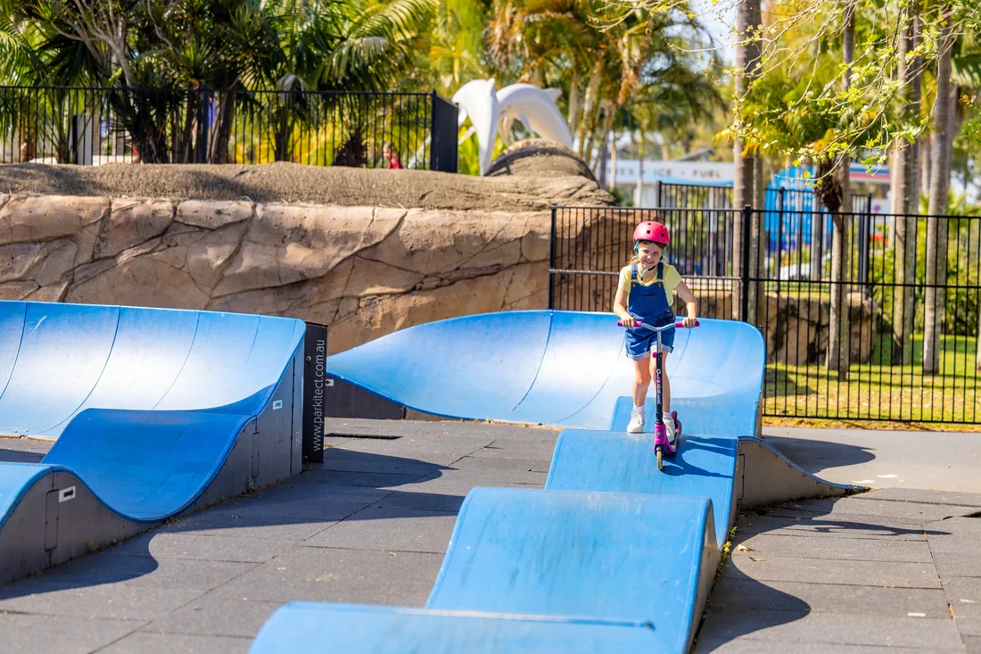 Kids on scooters and bikes at pump track, Blue Dolphin Holiday Resort, Yamba NSW