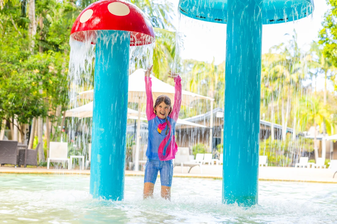 Girl plays in kids pool Angourie Resort Yamba