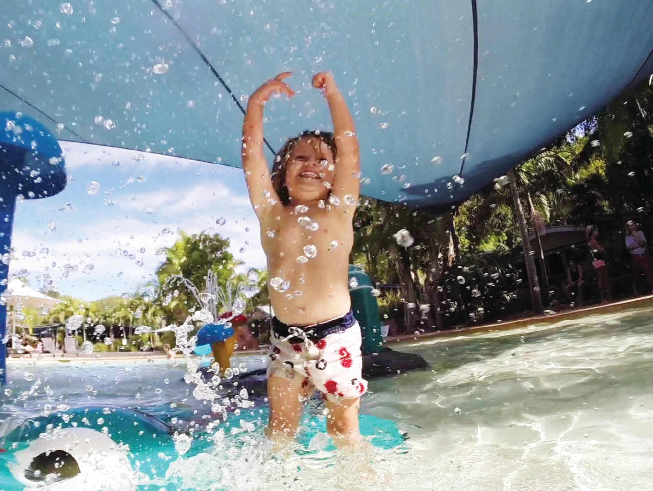 Young boy playing in splash park