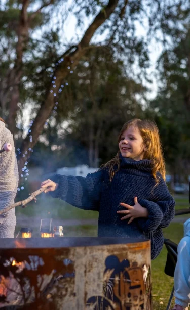 Family campfire at NRMA Darlington Beach Holiday Resort