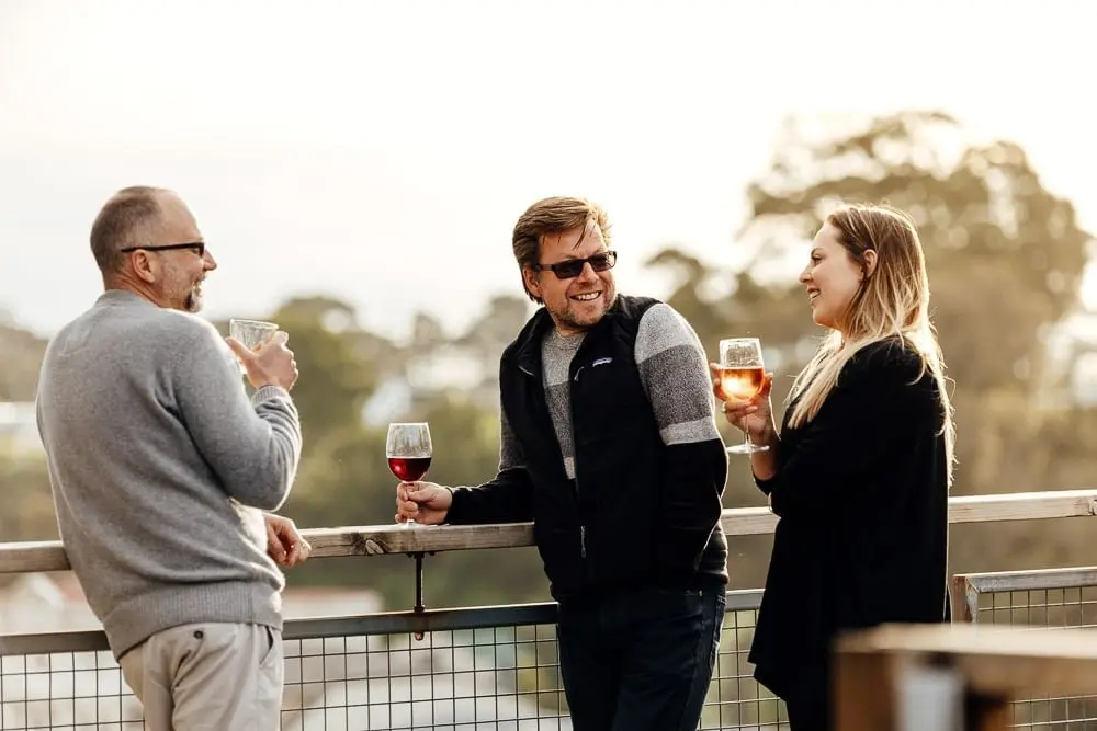 Friends having drinks by the terrace at Strahan Village