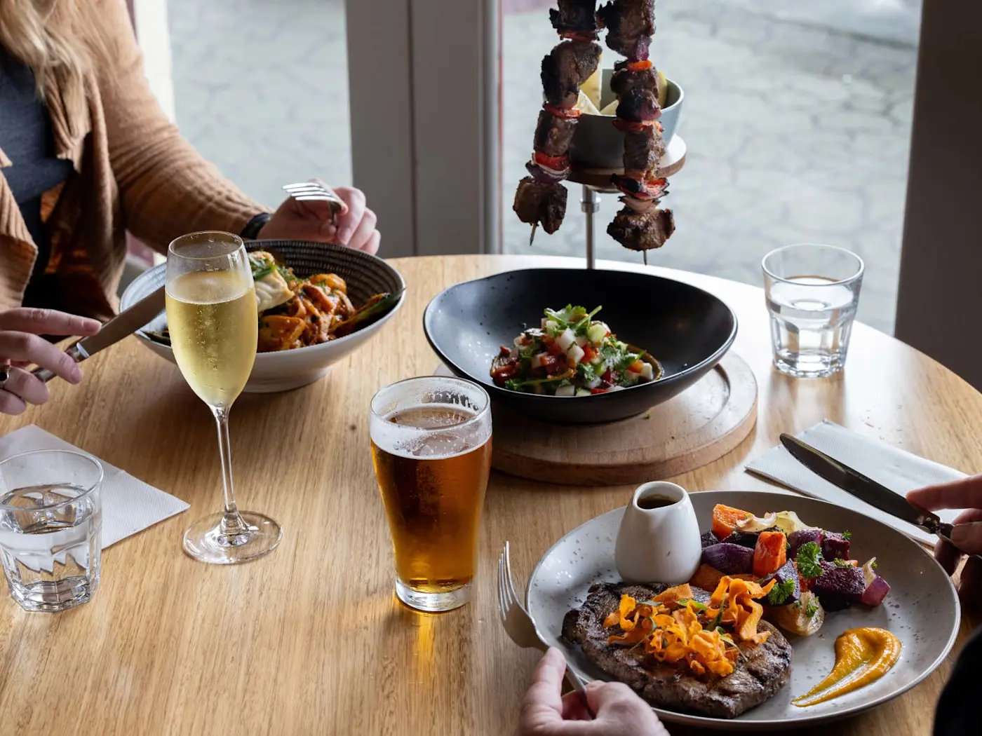 A couple enjoys a meal together in Hamer’s Bar & Bistro at Strahan Village