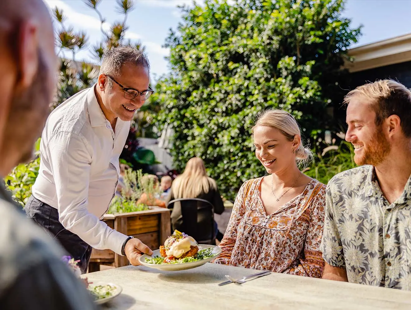 Friends eating at The Windmill Bargara 