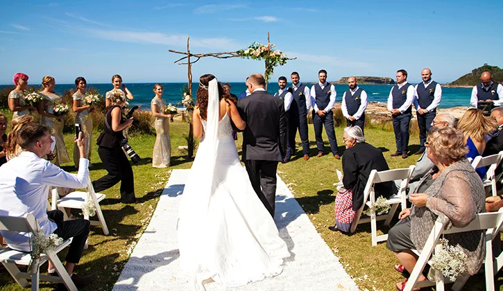 Bride and groom walking down the aisle in their beach side wedding
