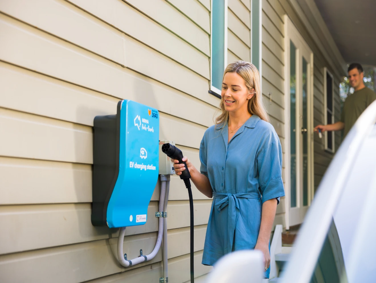 Lady using an EV charger