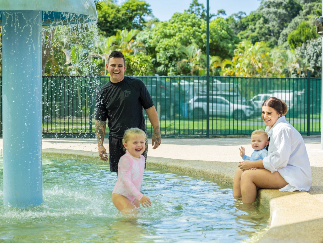 Family splashing in pool