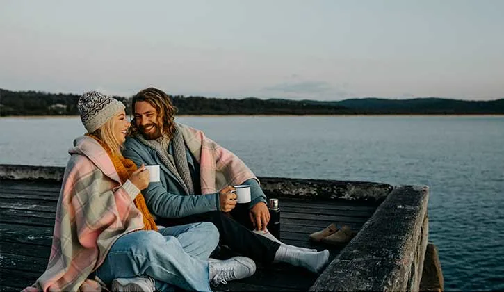 Couple sitting together at Tathra Wharf
