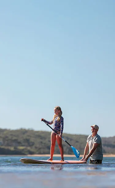 Young girl stand up paddle boarding