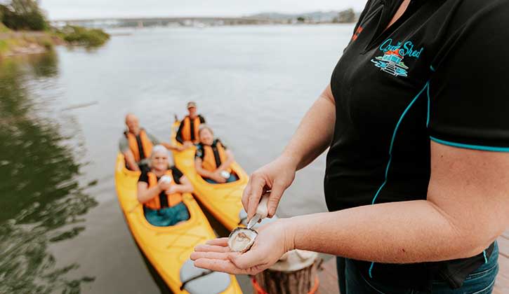 Eating oysters from kayaks at Broulee