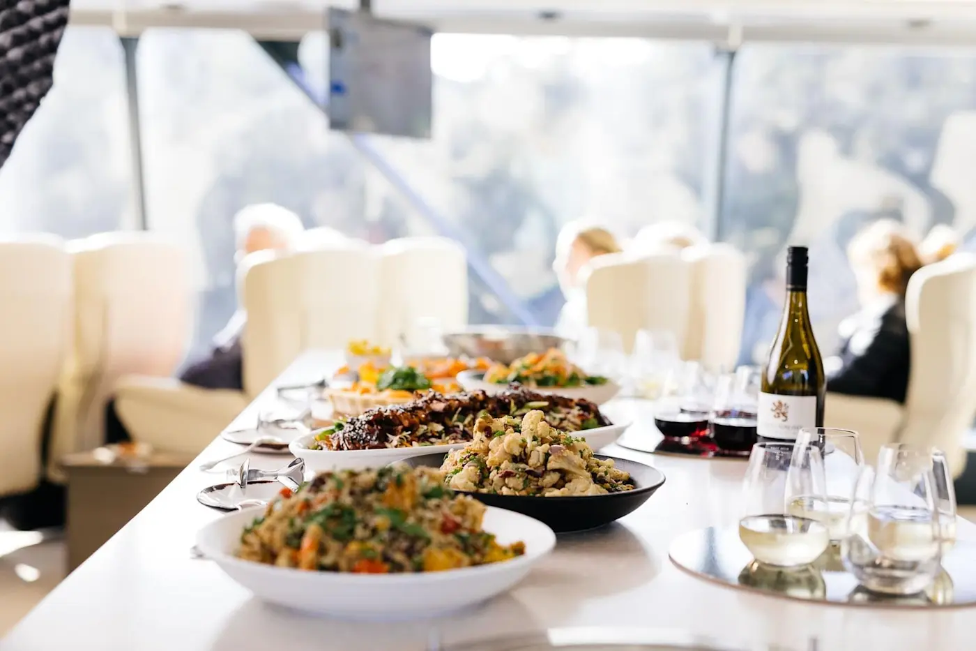 Champagne & dishes arranged on a table at Strahan Village