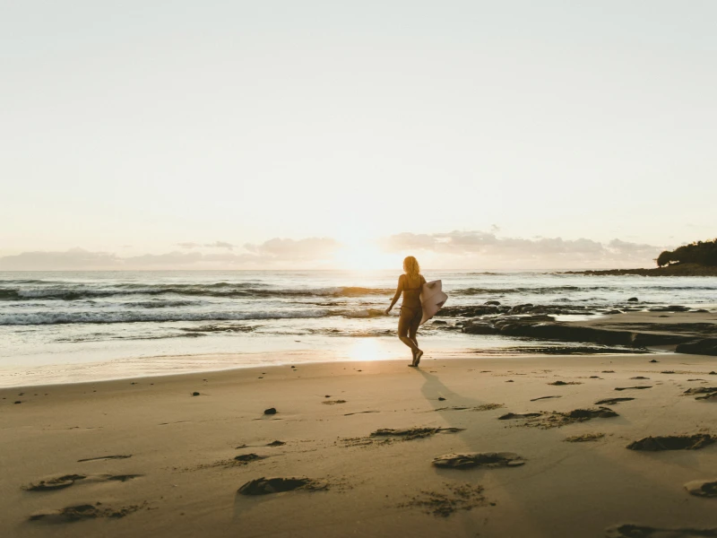 Surfer walking into the ocean