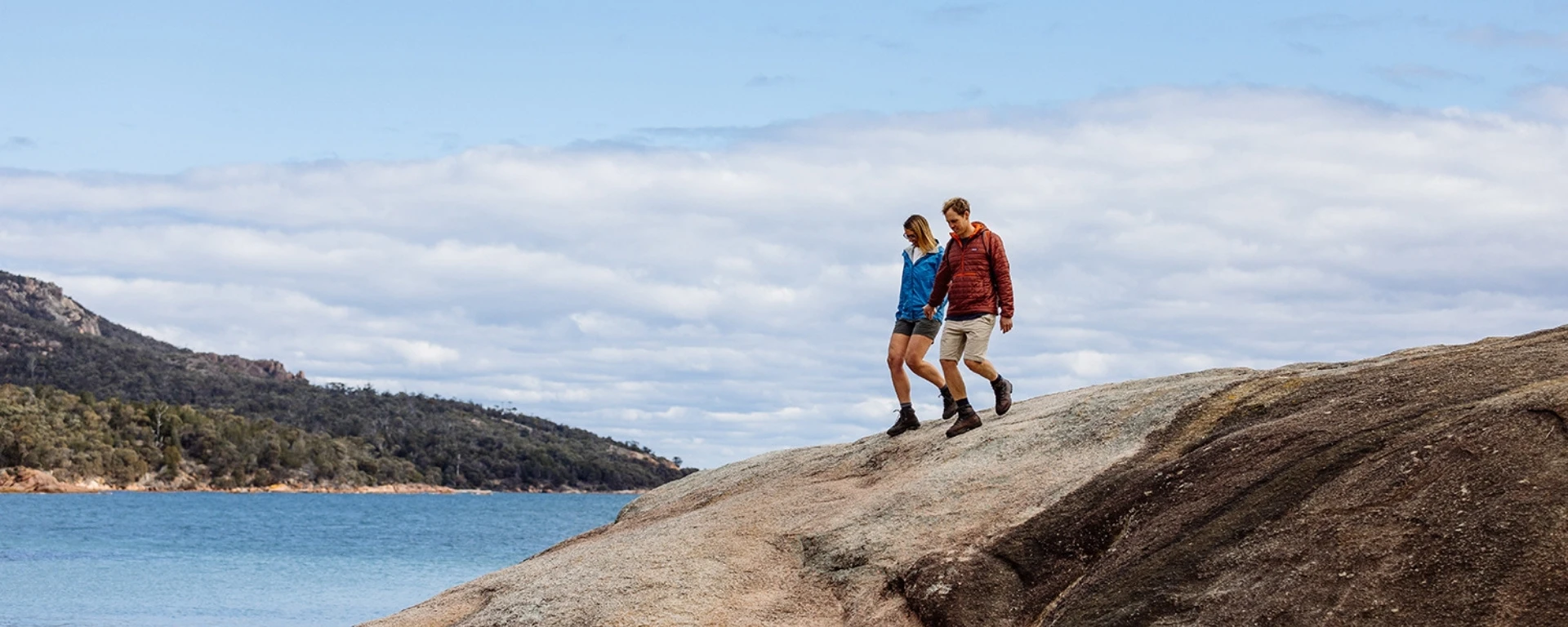 Couple walking near Freycinet Lodge