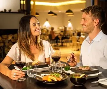 Couple having meal at the restaurant at Cradle Mountain Hotel