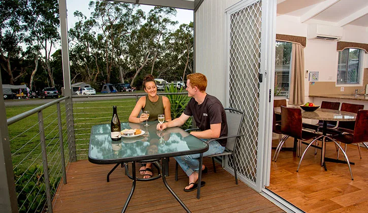 725x420 Halls gap holiday park couple sitting on villa deck