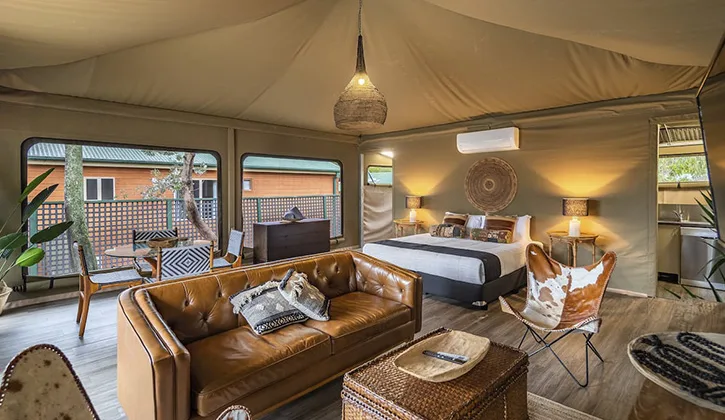 Lounge and bed in glamping tent