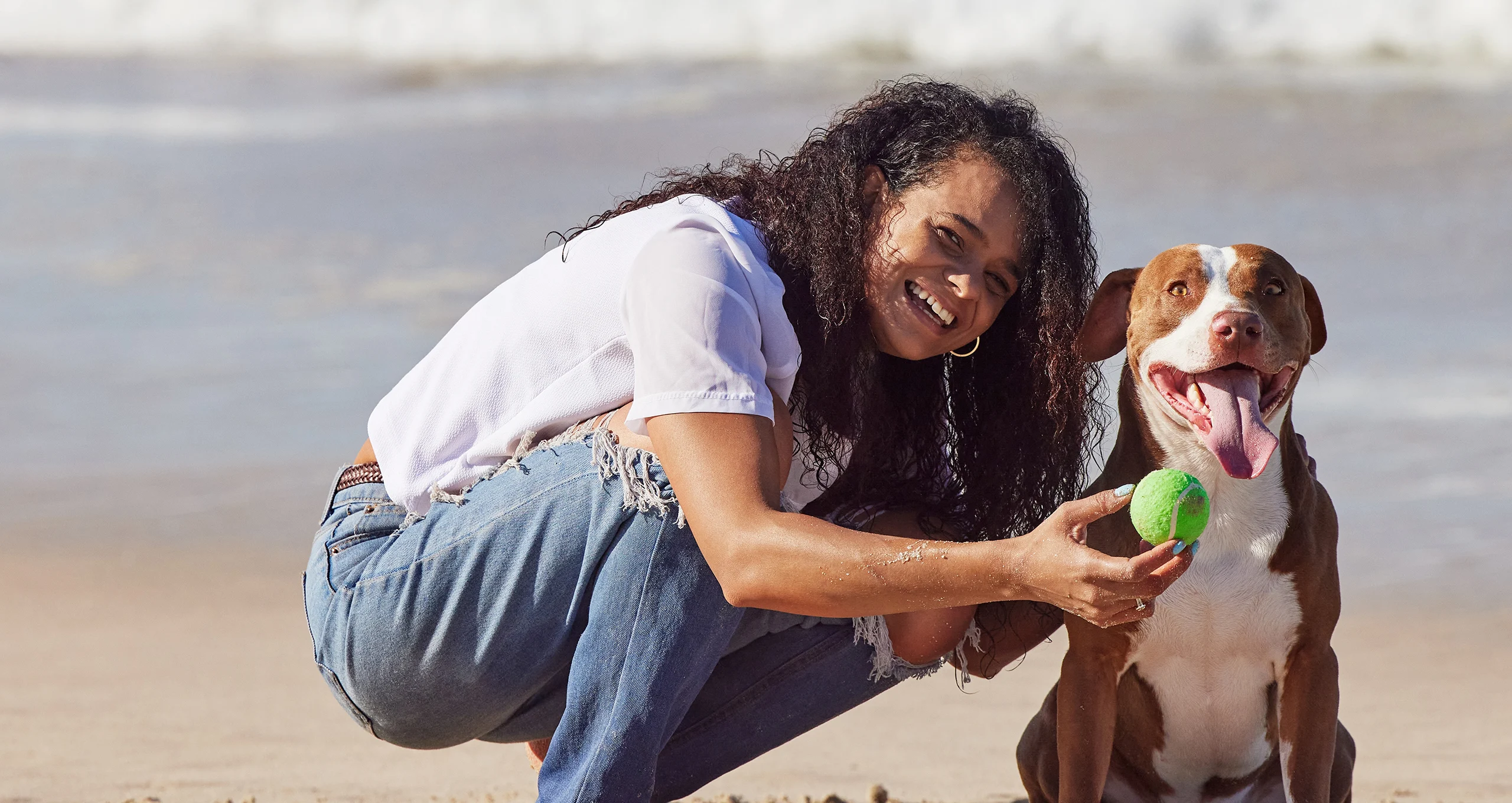 h woman with pit and tennis ball on beach
