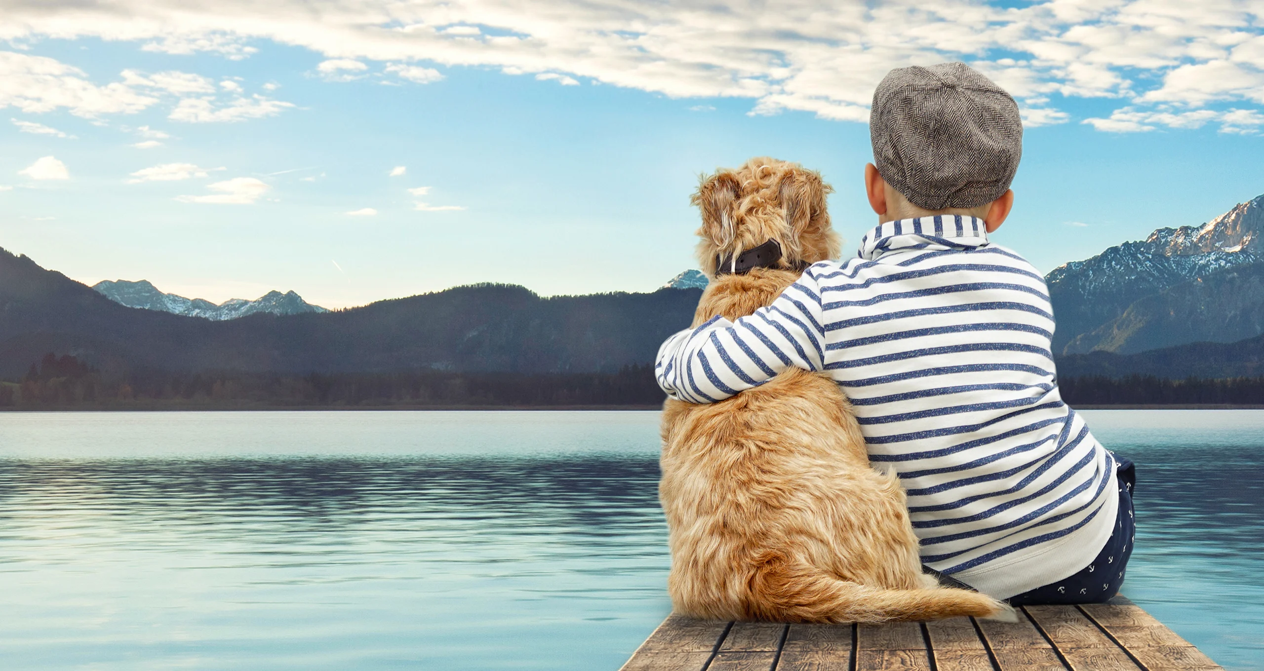 h dog and boy on dock on mountain lake