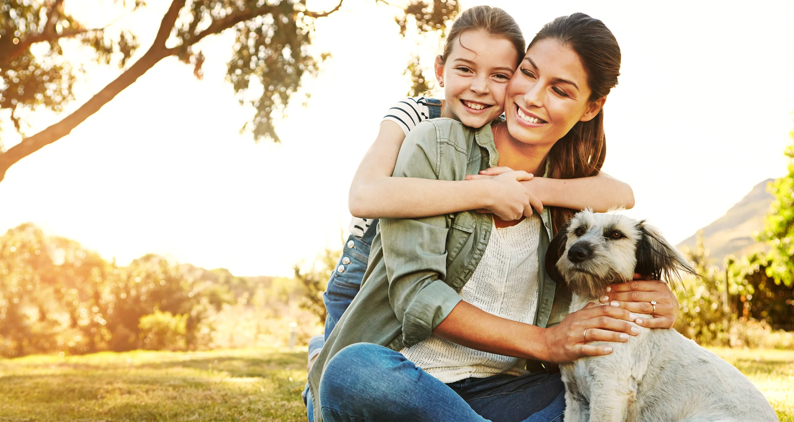 h mom and daughter with terrier mix at dusk in park