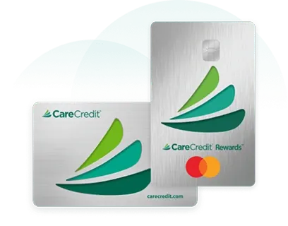 Two silver CareCredit credit cards, including a CareCredit Rewards Mastercard, with a green leaf design