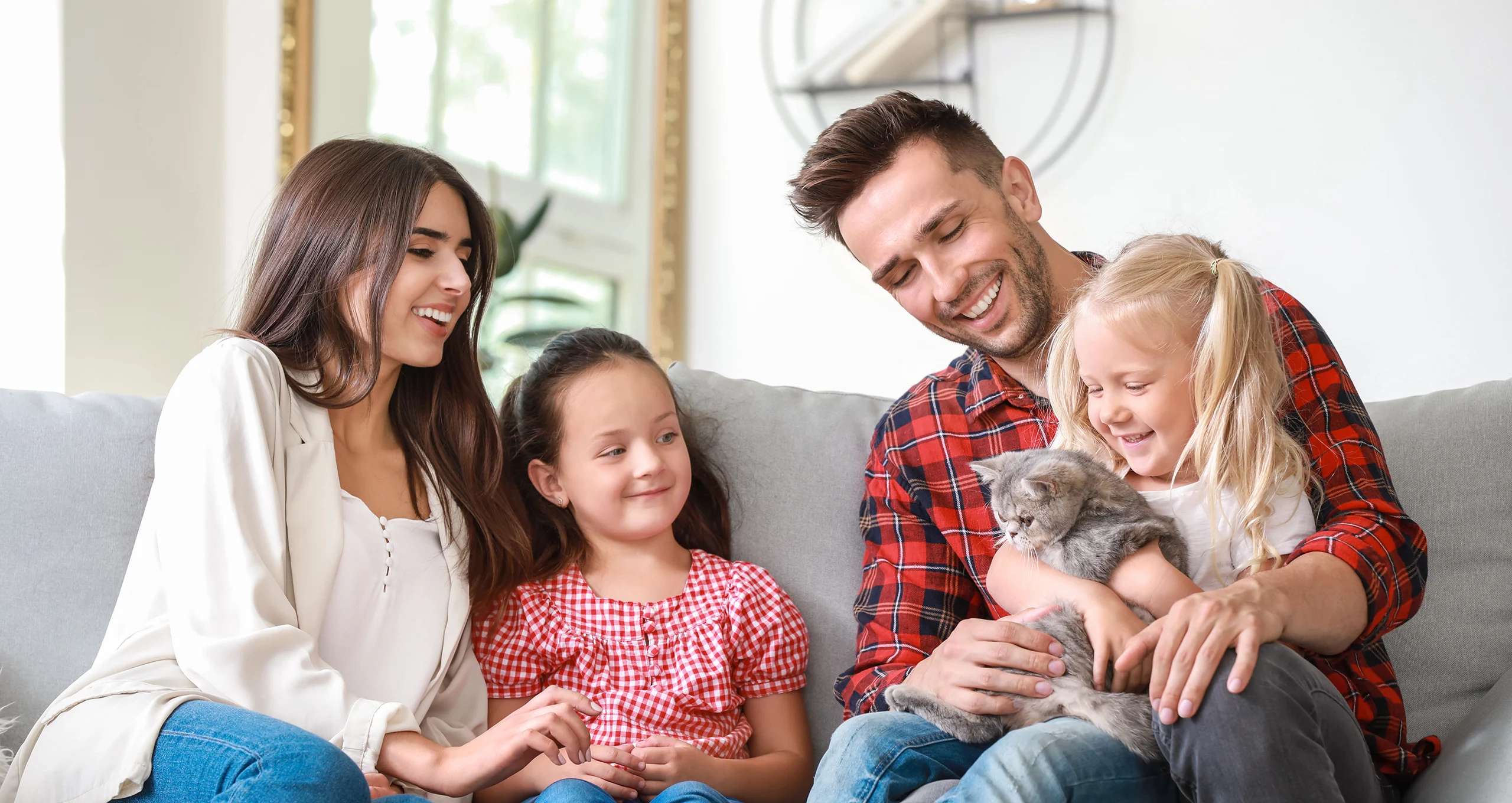 h family with kitten on couch