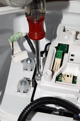PHOTO: Remove the control board mounting screw.