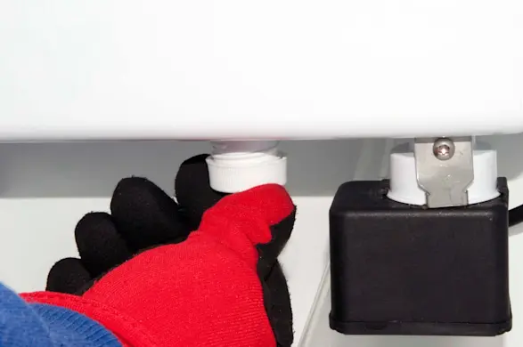 PHOTO: Remove the reservoir drain cap.