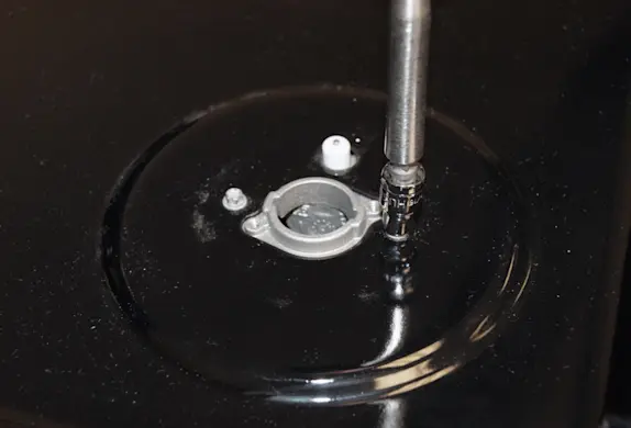 PHOTO: Remove the screws that hold down the cooktop.