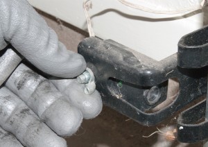 PHOTO: Remove the wing nut from the safety sensor.