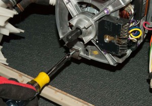 PHOTO: Remove the screws from the motor retainer clips.
