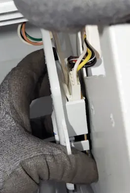 PHOTO: Release the wire harness locking tab.