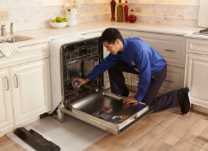 Sears Tech maintaining a dishwasher so it works efficiently.