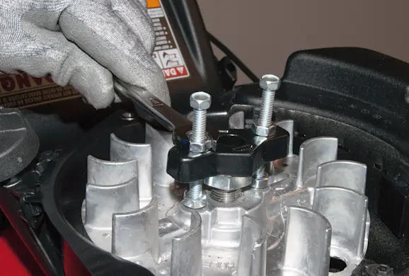 PHOTO: Remove the flywheel from the crankshaft.