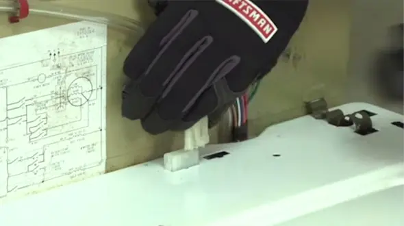 PHOTO: Plug in the lid switch wire harness back into the receptacle.