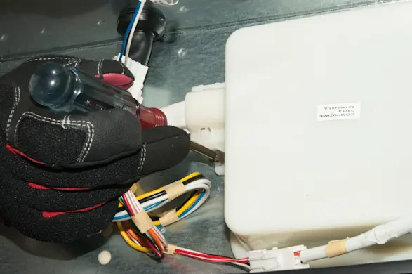 PHOTO: Mount the control board to the base of the cabinet.