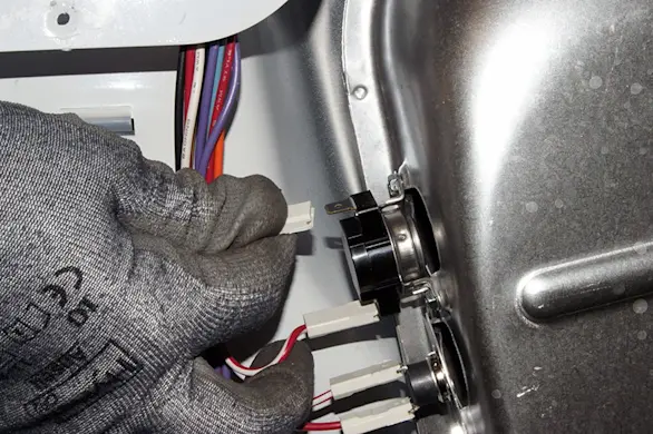 PHOTO: Remove the wires from the high-limit thermostat.