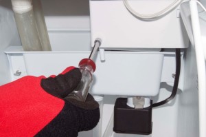 PHOTO: Remove the recirculation pump shield screw.