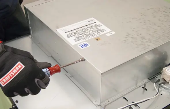 PHOTO: Remove the blower housing cover screws.