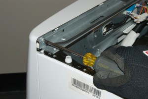 PHOTO: Remove the screw on the left back side of the control panel.