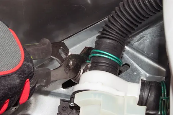 PHOTO: Release the washer drain hose clamp.