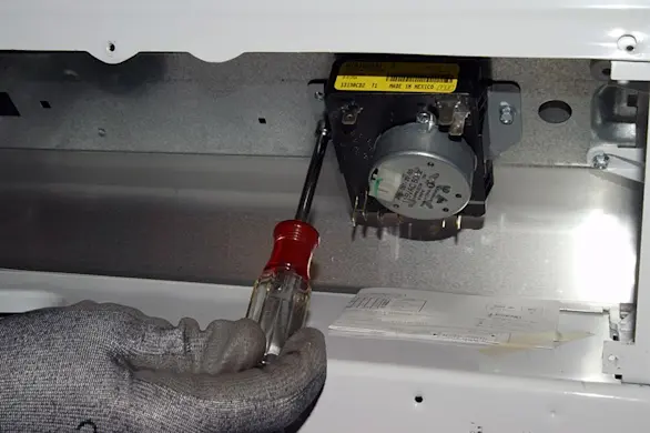 PHOTO: Remove the timer mounting screws.