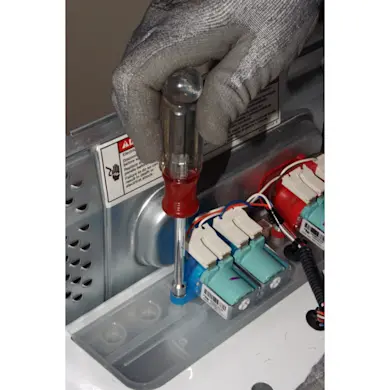 PHOTO: Remove the water inlet valve mounting screws.