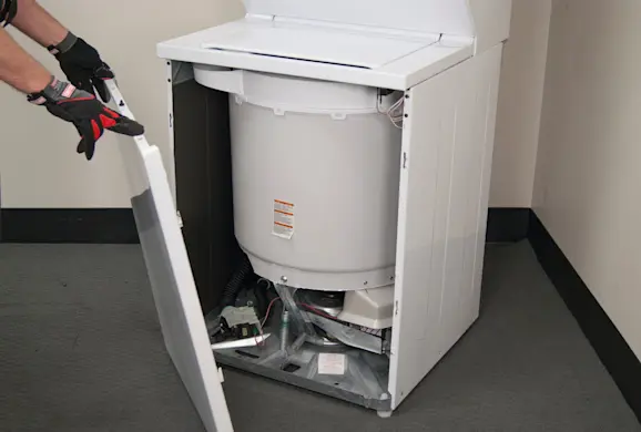 PHOTO: Remove the lower front panel from the laundry center.