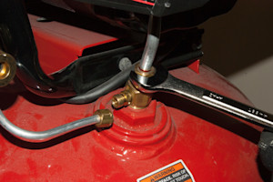 PHOTO: Disconnect the outlet tube from the check valve.