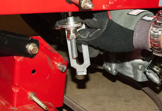 PHOTO: Release the hanging bracket from the mower deck.