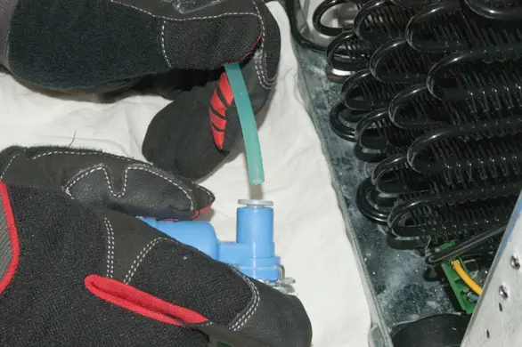 PHOTO: Disconnect the ice maker water supply line.