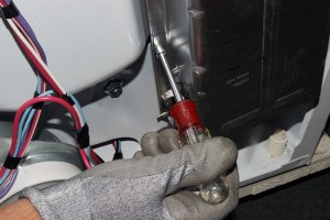 PHOTO: Remove the heating element mounting screws.