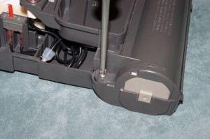 PHOTO: Remove the brush roller cover screws.